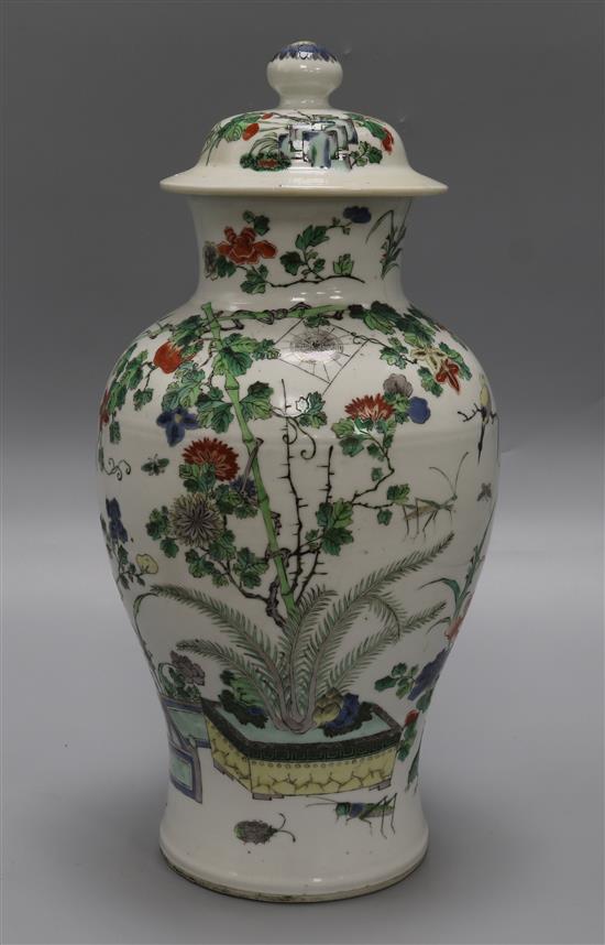 A Chinese famille verte vase and cover, late 19th century, height 37.5cm, hairline crack to rim, wood stand